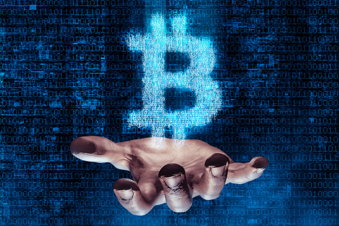 Hacker: Hand greift nach digitaler Währung Bitcoin