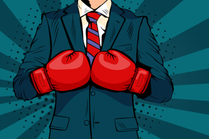 Kampf um die Marke: Business-Mann mit Boxhandschuhen