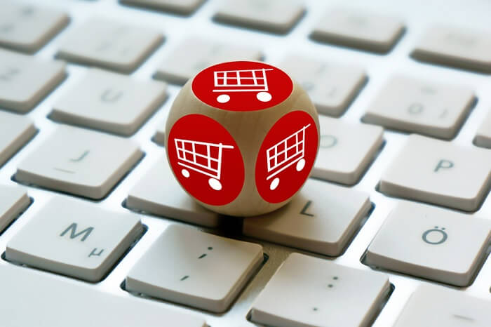 Würfel mit Einkaufswagen-Symbolen auf einer Tastatur