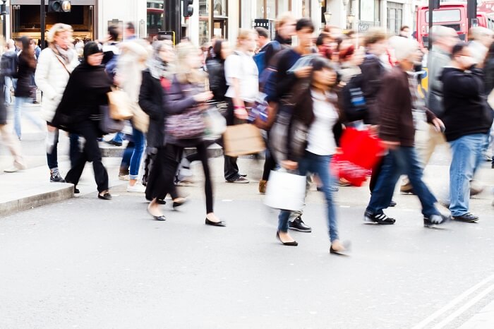 shopping people crossing a street in London